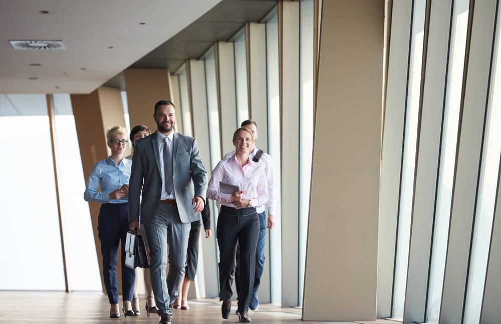 business team, businesspeople  group walking at modern bright office interior-1